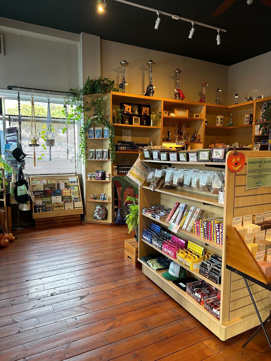 The Herb Stomp counter and wall of packaged herbs on warm wood floors